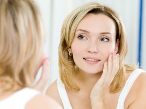 woman looking in mirror